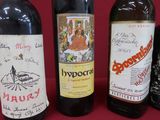 several bottles of wine are lined up on a red table