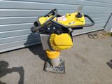 a yellow and black machine that is sitting on the ground