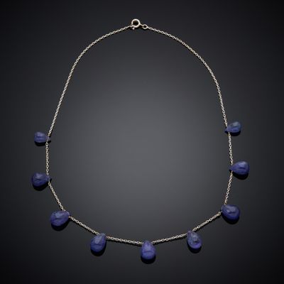 a necklace with blue glass beads on a silver chain