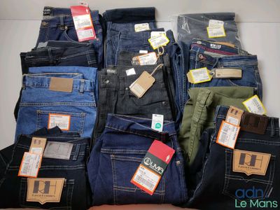 several pairs of men ' s jeans are stacked on top of each other