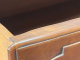 a close up of a wooden dresser with a drawer