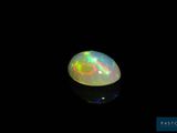 a white oplite in the dark with a black background