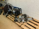 a small air compressor on a pallet next to a small air compressor