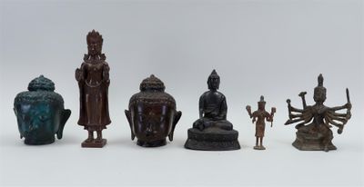a lot of asian figurines sitting on a white surface