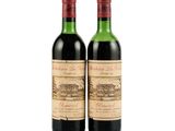 two bottles of wine sitting next to each other on a white surface