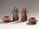 three red vases with handles and handles sitting next to each other