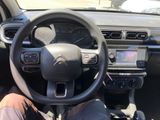 the interior of a car with a steering wheel and dashboard controls