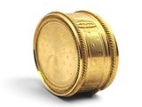 a gold coin sitting on top of a white surface