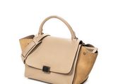 a beige handbag on a white background