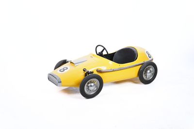 yellow toy race car on a white surface with a white background