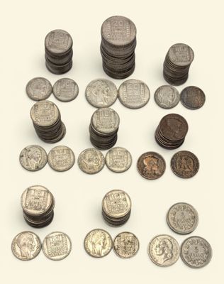a lot of coins that are on a white surface