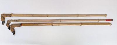 trois baguettes en bambou avec un manche rouge sur fond blanc