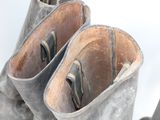 two pairs of boots that are sitting next to each other