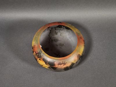a close up of a vase on a table with a gray background