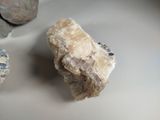 a rock that is sitting on a table next to some rocks