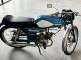 a blue motorcycle that is parked in a building