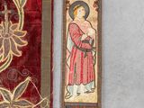 an image of a pair of red and gold cloths with a painting of a woman holding a child