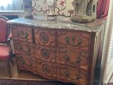 a dresser with a lamp on top of it in a room