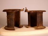 two wooden hats sitting on top of a wooden stand