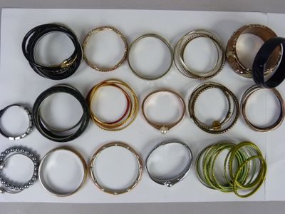 many different types of bracelets on a white tray