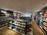 many shelves in the store with various items on them