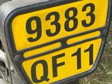 a close up of a motorcycle with a number plate on it