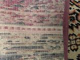an area rug with a pink border on top of it