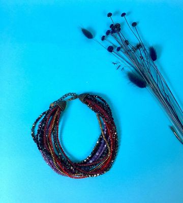 a close up of a bunch of beads on a blue surface