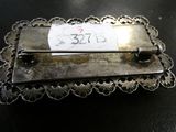 a small metal pin with a price tag on it