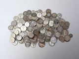 a pile of silver coins on a white surface