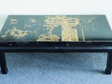 a black table with a green and gold design on it