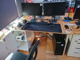 a desk with two computer monitors and a keyboard on it