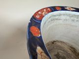 a blue and white vase with a flower design on it