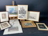 many framed pictures of different types of art on display