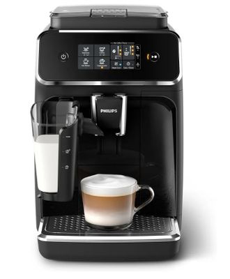 a black coffee machine with a glass of milk in front of it