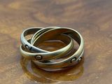 three rings on a wooden table with a blue sky in the background