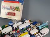 a lot of toy cars and a book on the table
