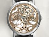 a close up of a watch on a white surface