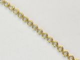 un gros plan d'un bracelet en or serti de diamants sur un fond blanc