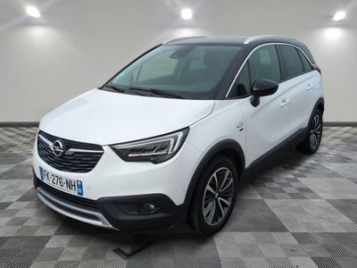 a white opel suv parked in a room with checkered floor