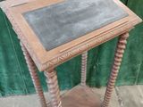 a small wooden table with a chalk board on it