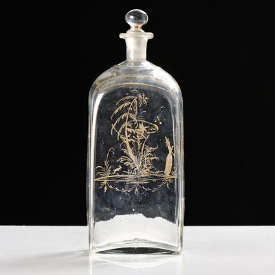 an old glass bottle with a picture of a man on a boat in a body of water