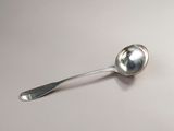a silver spoon with a spoon handle on a white surface