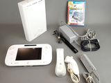a nintendo wii game system sitting on a table next to a nintendo wii game console
