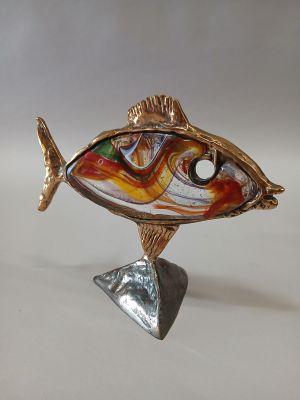 sculpture of a fish on a stand with a white background