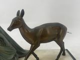 a statue of a deer and a tent on a table