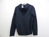 a black sweatshirt with a cow neck on a hanger on a wall