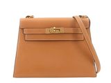 a tan leather handbag with gold hardware