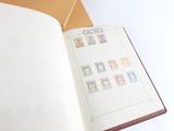 an open book with stamps on it sitting on a table