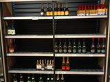many bottles of beer on the shelves in the store